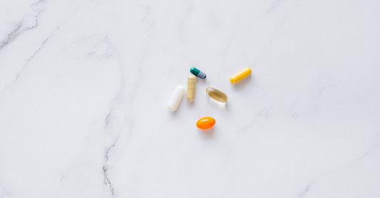 Potassium gluconate vs citrate supplement capsules on a white background, comparing two forms of potassium for long-term electrolyte maintenance.