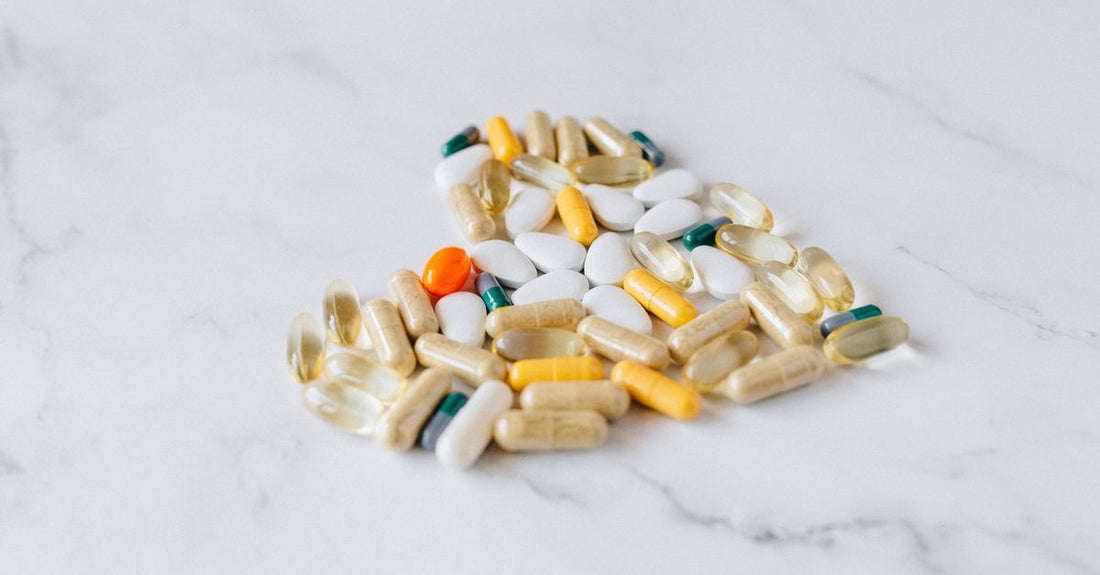 A multivitamin bottle and scattered capsules on a clean white surface, representing the multivitamins buying guide UK
