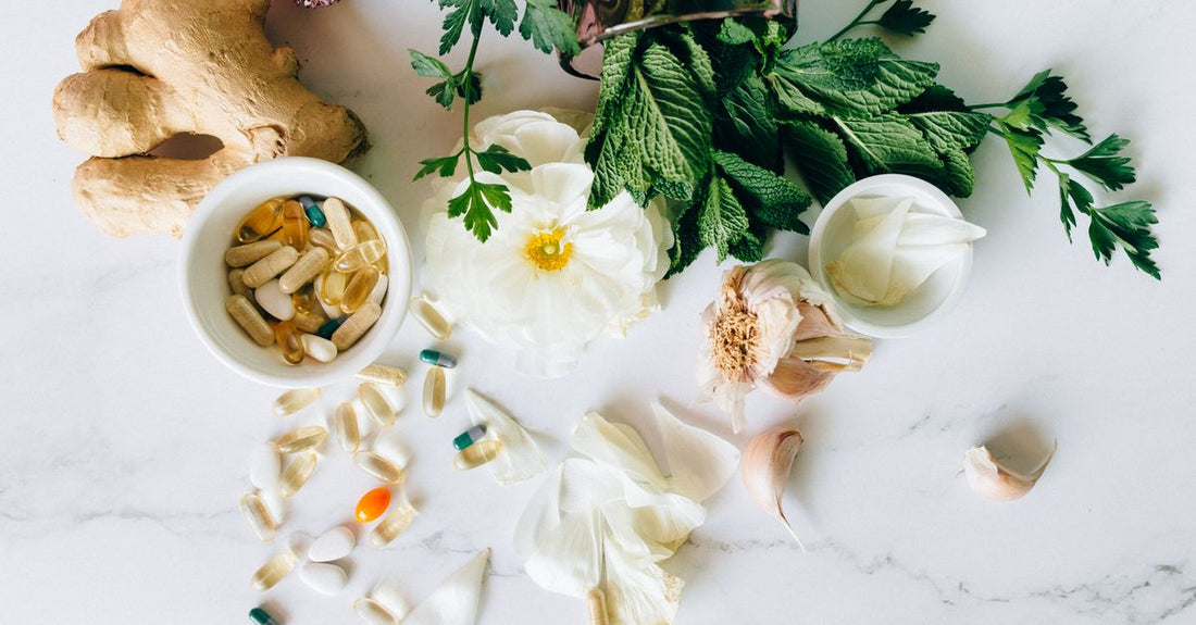 A flatlay of various herbal supplement bottles and dried herbs, illustrating alternative medicine buying guide UK