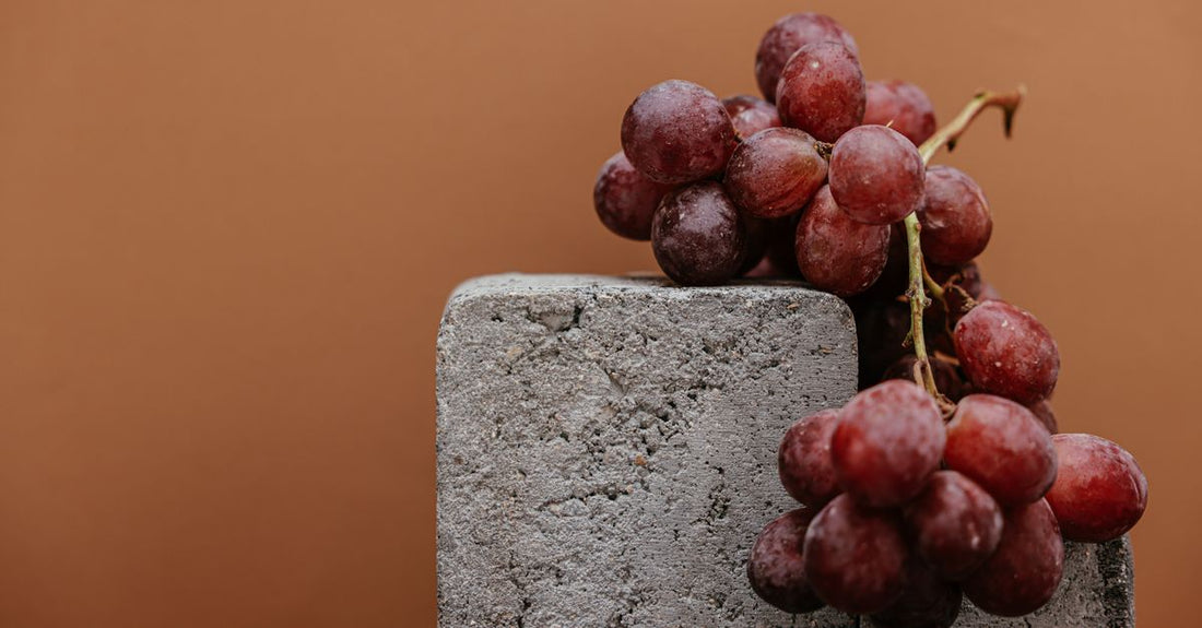 Resveratrol for longevity supplement capsules on a clean surface, showcasing the deep purple colour of trans-resveratrol.