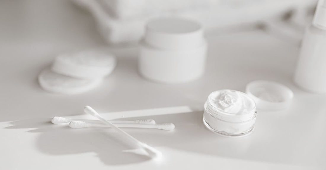 A collection of ointment jars and tubes on a clean surface, illustrating the ointments buying guide UK.