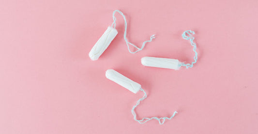 A box of organic tampons UK shoppers trust, displayed on a clean bathroom shelf with a white background.