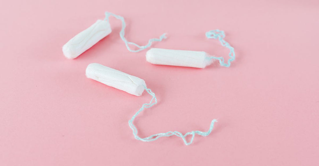 Selection of tampon boxes displayed on a clean surface, illustrating how to choose tampons UK for a complete routine.