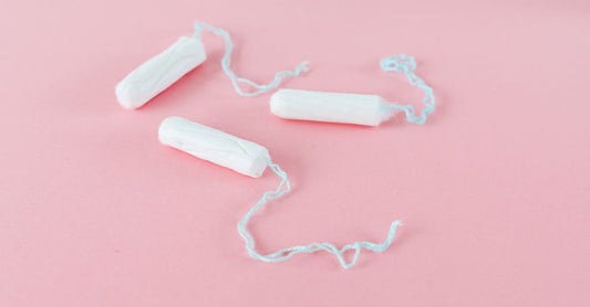Selection of tampon boxes displayed on a clean surface, illustrating how to choose tampons UK for a complete routine.