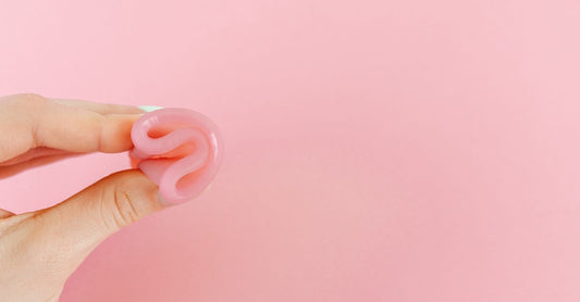 A soft pink silicone menstrual cup shown against a clean white background, illustrating how to choose menstrual cups UK.