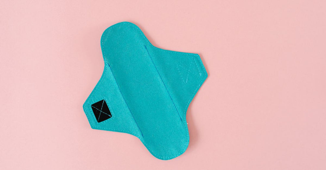 Reusable underpad flatlay on a white background, showing quilted layers, as featured in our reusable underpads buying guide UK.