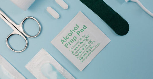 Flatlay of alcohol prep pads 70 isopropyl in sterile individual wrappers on a clean surface, highlighting medical-grade packaging.
