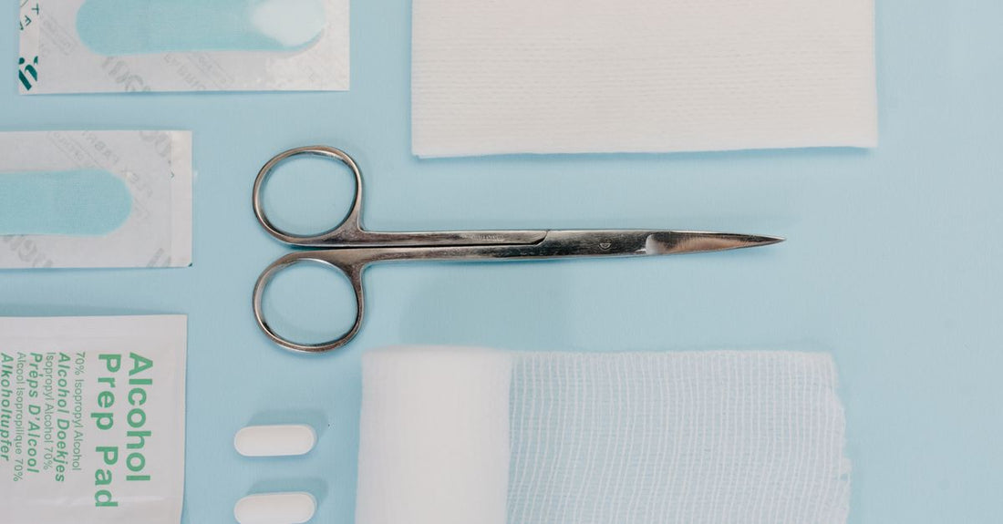 Assorted waterproof bandages for cuts laid flat on a clean white surface, showing different sizes and transparent edges.