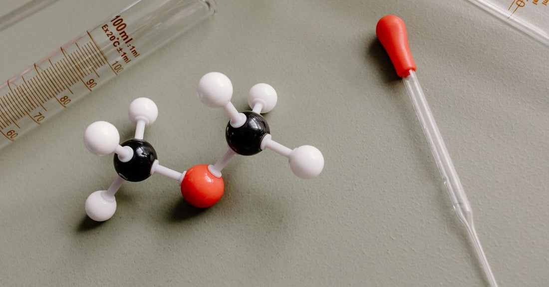 A bottle of acetyl L carnitine capsules beside a glass of water on a light background, representing acetyl l carnitine weight loss support.