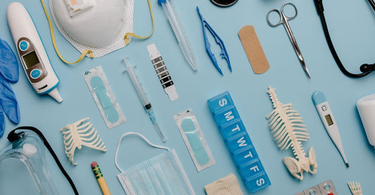 Flatlay of first aid supplies including gauze rolls, haemostatic dressings, and a trauma kit for a first aid buying guide UK.