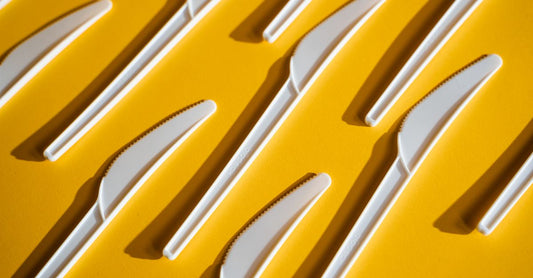 Yellow sharps container with biohazard symbol for safe needle disposal in UK homes
