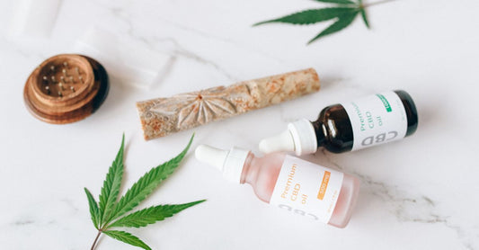 A bottle of golden hemp seed oil and a scoop of green hemp protein powder on a wooden surface, representing the best hemp UK 2026 products.