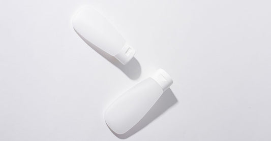 A minimalist bottle of gentle facial cleanser for sensitive skin on a light background.
