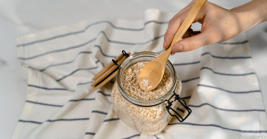 Jar of dietary fibre supplement powder with a scoop on a light background, representing a dietary fibers buying guide UK.