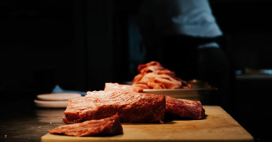 A butcher's block displaying various raw beef cuts with visible marbling, illustrating the beef buying guide UK.