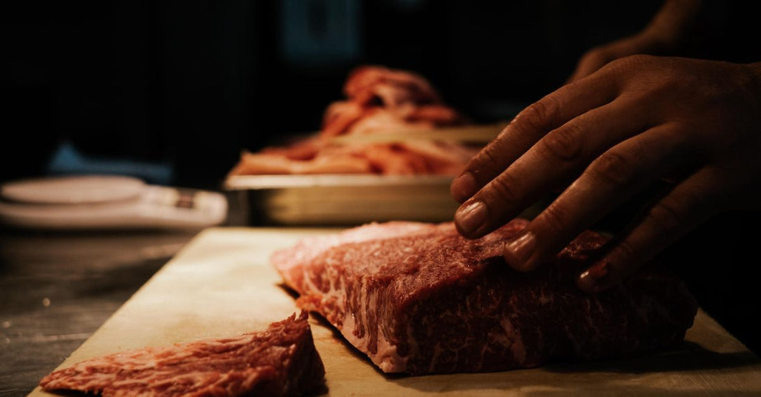 Selection of British beef cuts displayed on a butcher's block for a beef buying guide UK