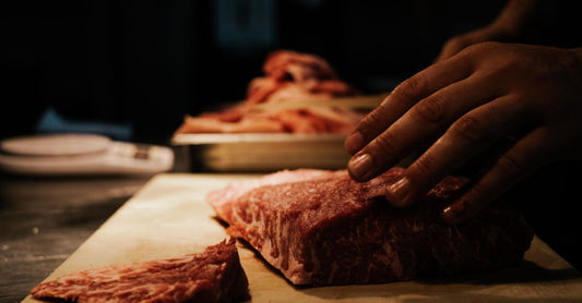 Selection of British beef cuts displayed on a butcher's block for a beef buying guide UK