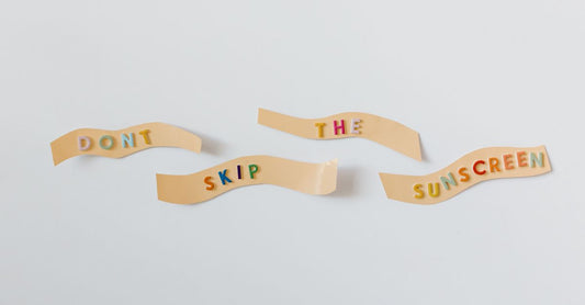 Assorted adhesive bandages in sterile packaging on a clean white surface, showing fabric and clear plastic options for UK wound care