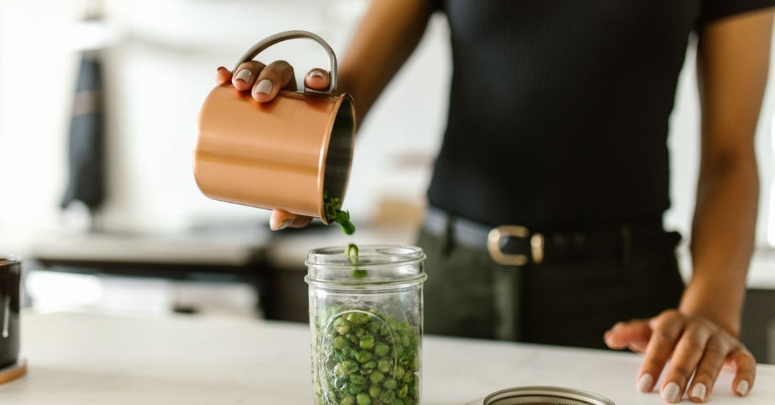 A glass jar of fine-textured pea protein powder on a clean surface, representing high-quality pea protein powder UK supplements.