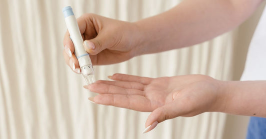 A flat lay of diabetic foot care essentials including non-binding socks, moisturising cream, and a foot inspection mirror on a clean white surface, illustrating the diabetic foot care buying guide UK.