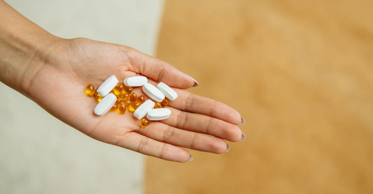 A collection of chondroitin supplement capsules and tablets on a white surface, representing a chondroitin buying guide UK for joint health.