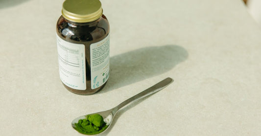 A jar of collagen powder supplements for skin elasticity on a neutral surface.