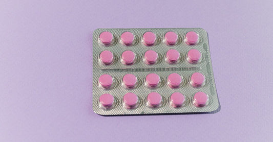 Bottle of best charcoal UK 2026 activated charcoal capsules on a clean white background with scattered capsules.