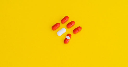 A selection of vitamin and supplement bottles arranged on a clean white surface, illustrating how to choose combinations UK for optimal health.