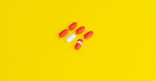 Assortment of prenatal vitamin capsules and softgels arranged on a neutral surface, illustrating a prenatal vitamins buying guide UK.