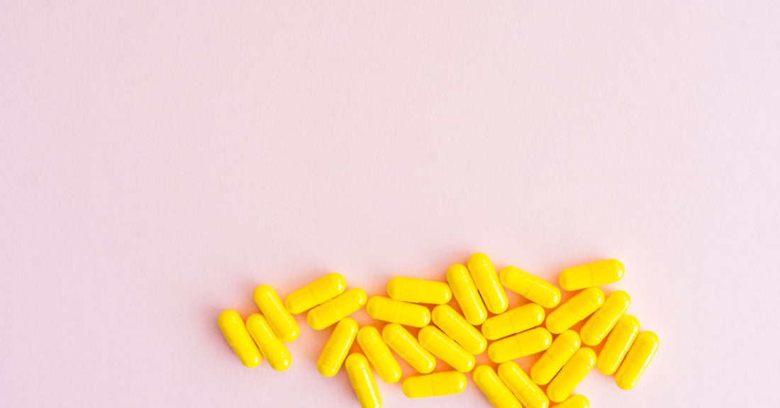 A bottle of CoQ10 supplement capsules alongside a few softgels, representing the CoQ10 buying guide UK for informed supplement choices.