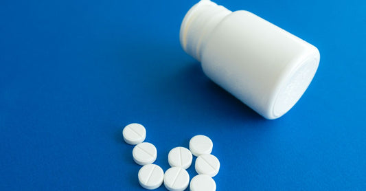 Five vitamin B12 supplement bottles lined up on a bright white surface, showing their labels clearly to help compare the best B12 2026 options available in the UK.