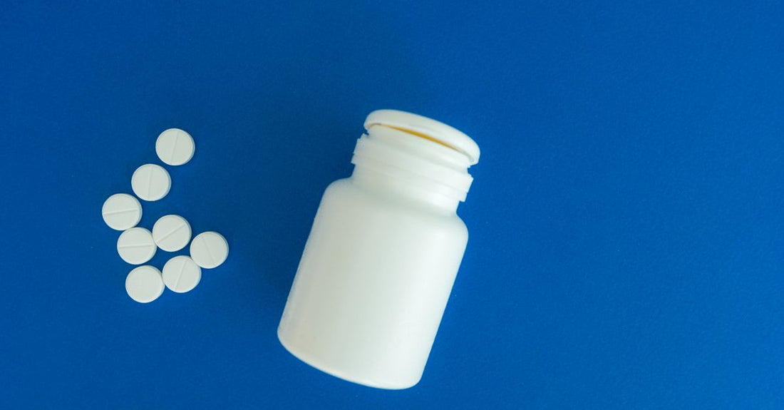 Assorted herbal supplements and vitamin bottles arranged on a light background, illustrating the alternative medicine buying guide UK.