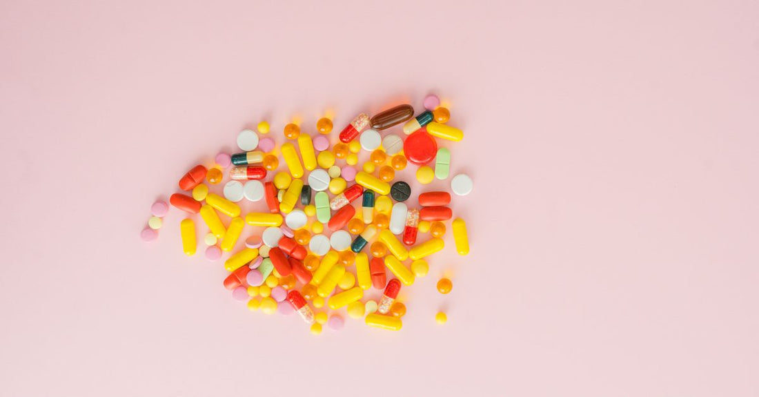 A selection of vitamin B-complex capsules and bottles arranged on a clean surface, illustrating how to choose b-complex supplements.