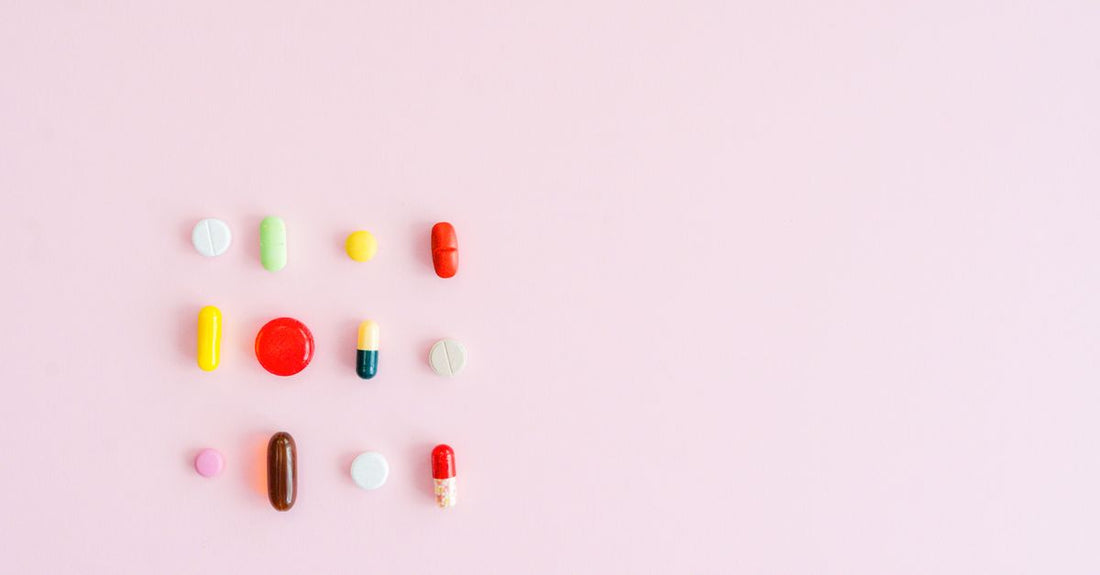 Assorted magnesium supplement capsules and tablets on a clean white surface, illustrating how to choose magnesium UK.