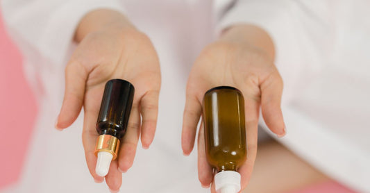 Black currant oil capsules beside a fresh bottle on a white background, illustrating a UK black currant oil buying guide.